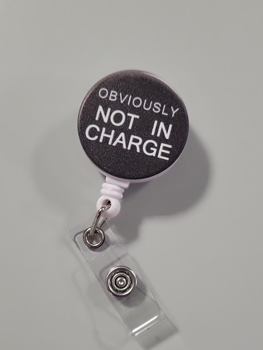 4/$20 Retractable Badge Reel - Black "Obviously Not In Charge"